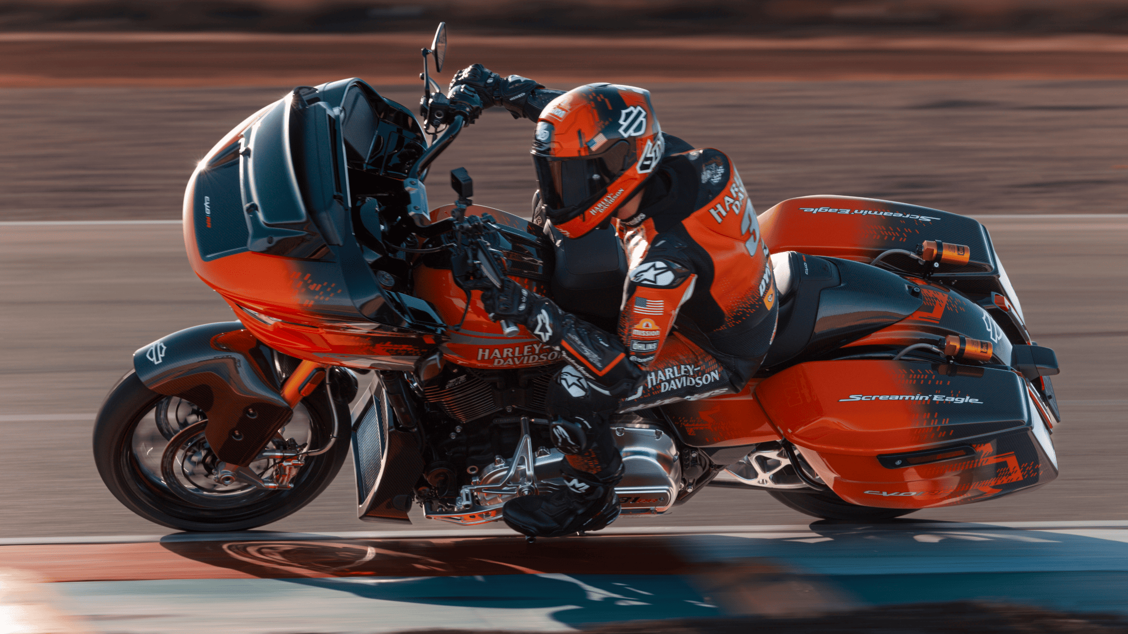 Racer leans 2025 Harley-Davidson® CVO™ Road Glide® RR through turn on closed circuit racetrack