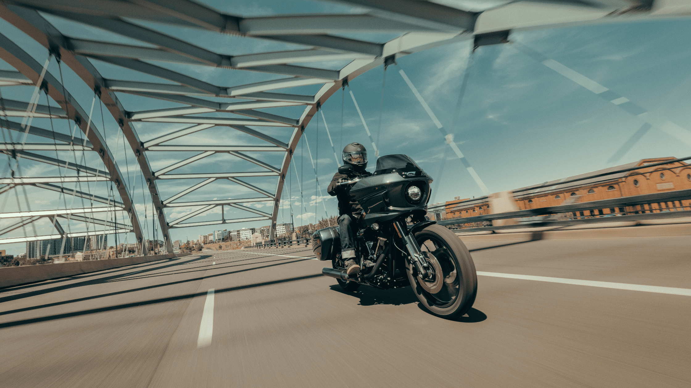 2025 Harley-Davidson Low Rider ST black motorcycle, rider crossing bridge in Augusta, GA