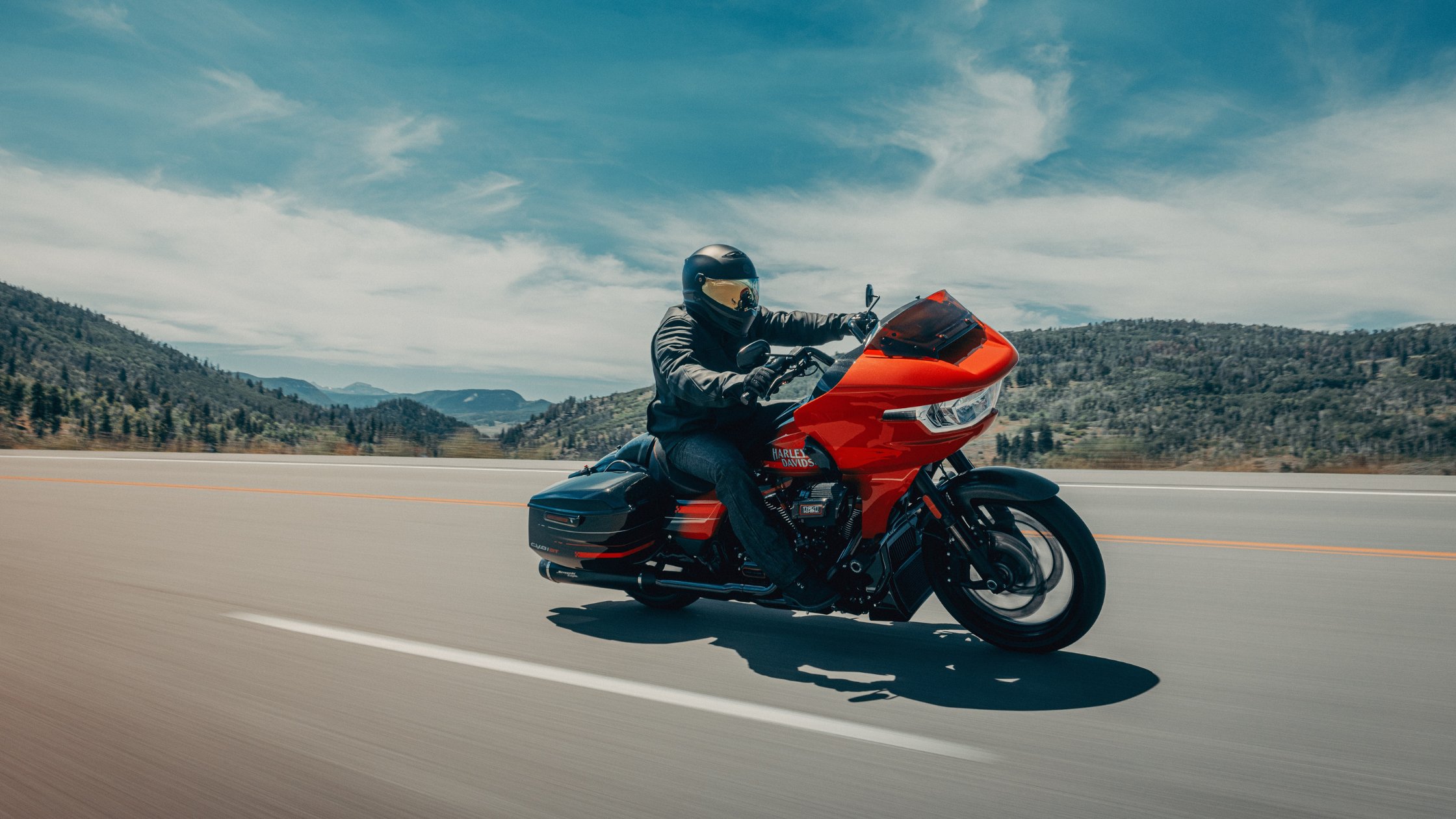 2026 H-D® CVO™ Road Glide® ST performance touring motorcycle riding mountain highway
