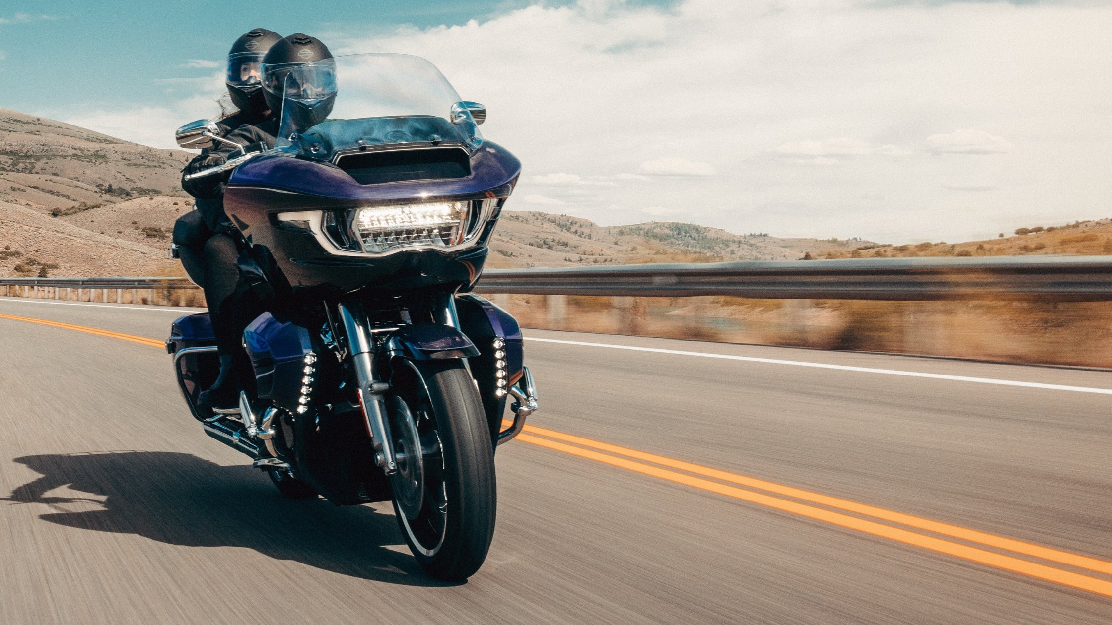 Two riders on blue 2026 Harley-Davidson® Road Glide® Limited cruising open desert highway