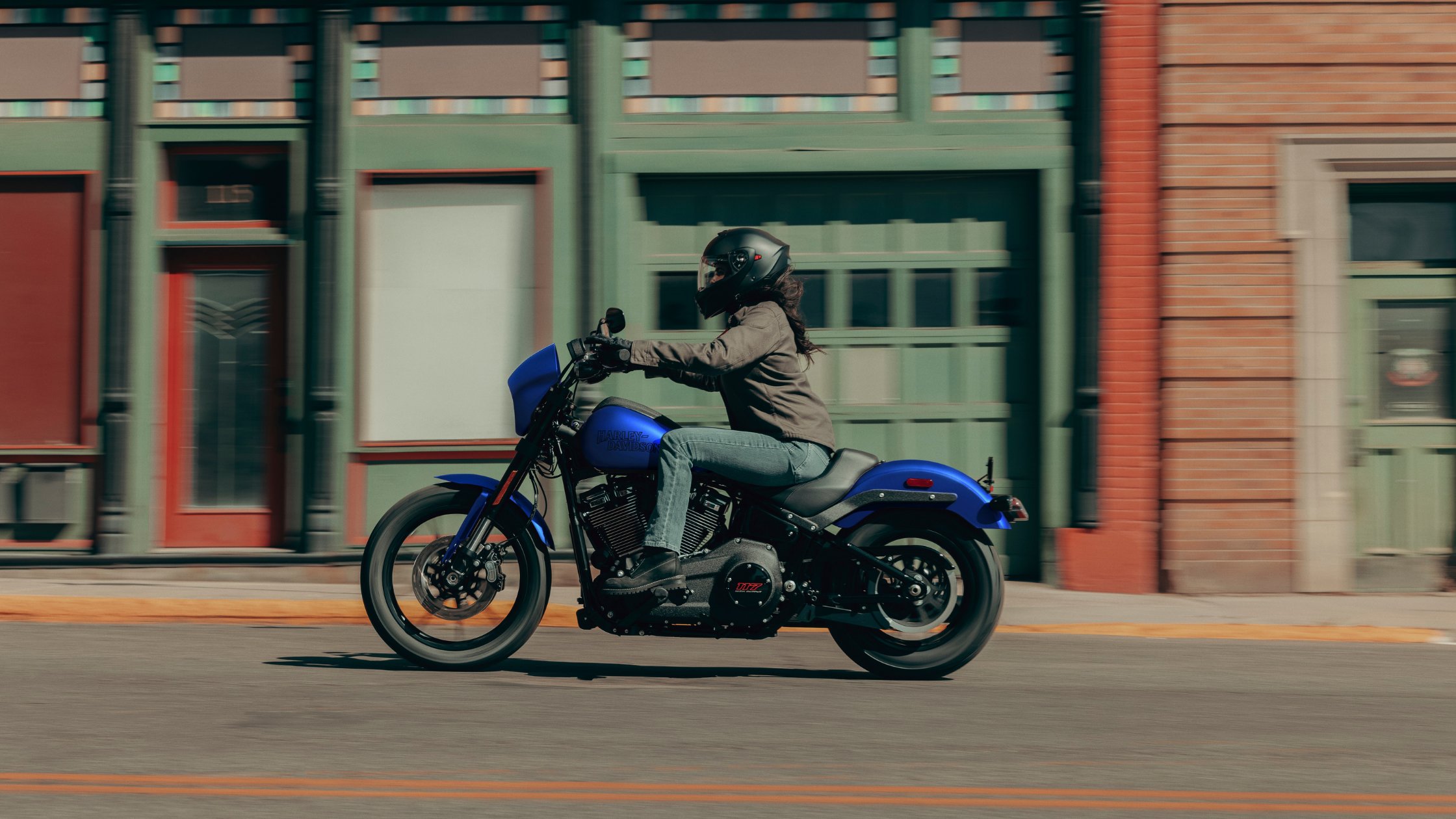 Blue 2026 Harley-Davidson® Low Rider® S ridden through downtown streets by a helmeted rider