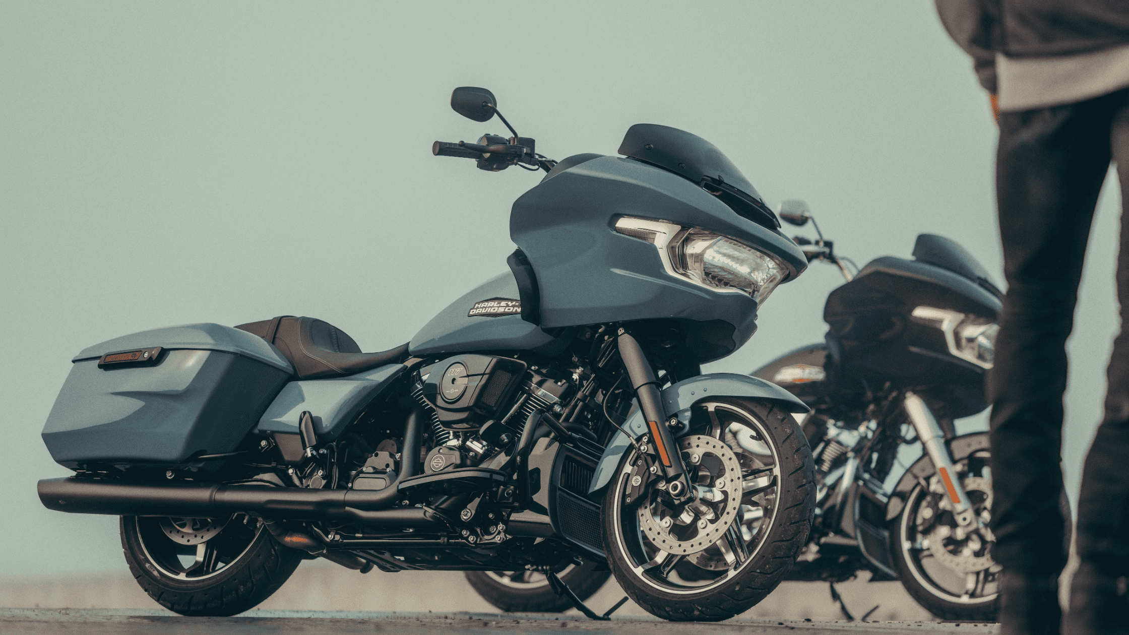 Close-up of 2025 Harley-Davidson Road Glide with rider standing nearby, second bike in background.